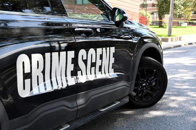 Baltimore forensics team investigates a shooting after a Baltimore Police officer and a security guard exchanged gunfire Wednesday with the suspect in a separate shooting, the police department said. Officers arrived around 10:49 a.m. to the 2700 block of Spelman Road in Chery Hill for a report of a shooting. They found a 33-year-old man with what appeared to be life-threatening gunshot wounds. Medics took him to the hospital, and he is in critical condition, police said Wednesday afternoon. (Kim Hairston/staff)