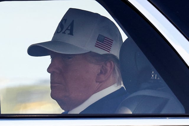 U.S. President Donald Trump sits inside a vehicle, after disembarking Air Force One, as he arrives to attend the world leader meeting of the North Atlantic Treaty Organization (NATO) in The Hague, at Amsterdam Airport Schiphol in Schiphol, Netherlands, June 24, 2025. REUTERS/Piroschka Van De Wouw