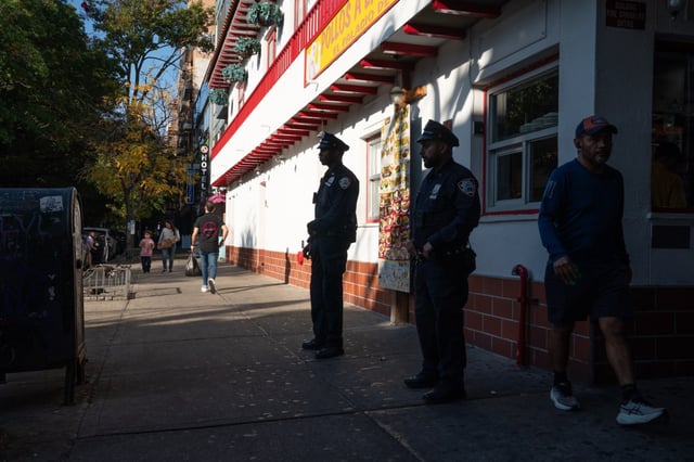 Officers assigned to “Operation Restore Roosevelt” stand foot post at the intersection of Roosevelt Ave. and 81th St. Tuesday, Oct. 22, 2024 in Queens, New York. ) (Barry Williams for New York Daily News)