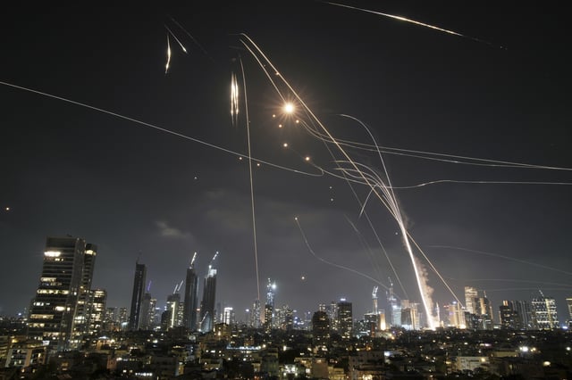 FILE - Israeli Iron Dome air defense system fires to intercept missiles over Tel Aviv, Israel, on June 13, 2025. (AP Photo/Leo Correa, File)