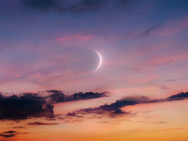 New Moon in the sky at sunset. 