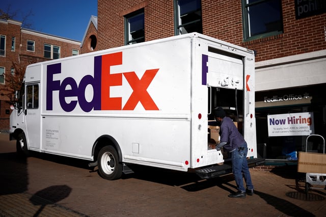 A driver of FedEx loads packages into a delivery truck during Black Friday preparations in the Georgetown neighborhood of Washington, U.S., November 26, 2024. REUTERS/Benoit Tessier/File Photo