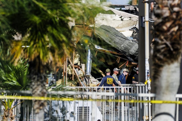 FBI investigate the scene at The American Reproductive fertility clinic the day after a car bomb exploded in the parking lot in Palm Springs, Calif., in May.