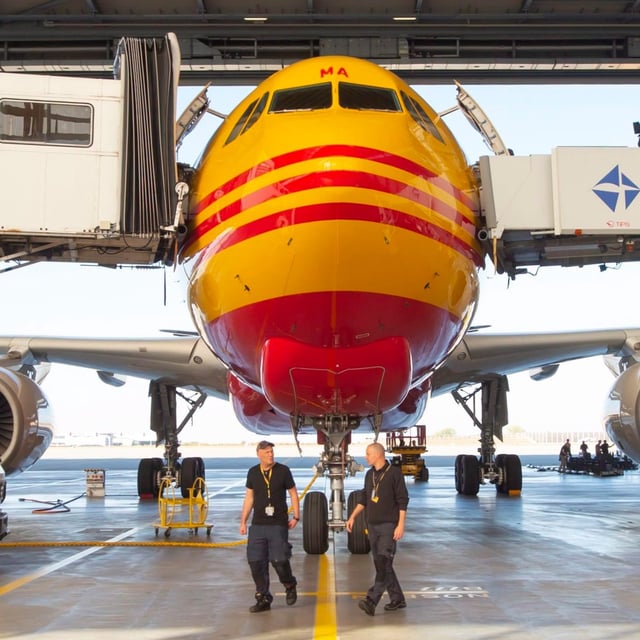 A DHL Express airplane stands in the hangar during the official launching ceremony of the Airbus A330-200 cargo airplane by the European Air Transport Leipzig GmbH (EAT) at the DHL's European air freight hub in Schkeuditz near Leipzig, Germany, Friday, Oct. 12, 2018. (AP Photo/Jens Meyer)