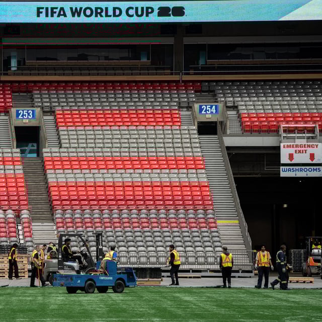 Workers clear the turf at B.C. Place during a FIFA World Cup 2026 update in Vancouver, Tuesday, April 30, 2024. THE CANADIAN PRESS/Ethan Cairns