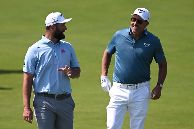Jon Rahm of Spain (L) and Phil Mickelson of the United States walk across the third hole during a practice round prior to the 125th U.S. OPEN at Oakmont Country Club on June 11, 2025 in Oakmont, Pennsylvania.
