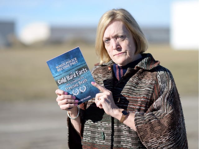 This 2016 file photo shows Candis McLean holding a copy of her book "When Police Become Prey: The Cold Hard Facts of Neil Stonechild’s Freezing Death."