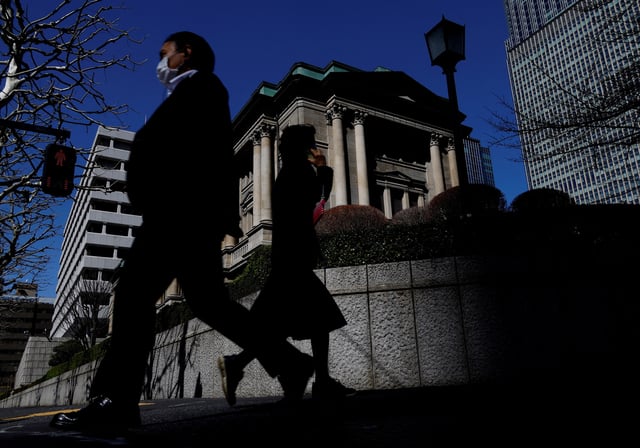 Pedestrians walk past the Bank of Japan building in Tokyo, Japan March 18, 2024. REUTERS/Kim Kyung-Hoon/File Photo