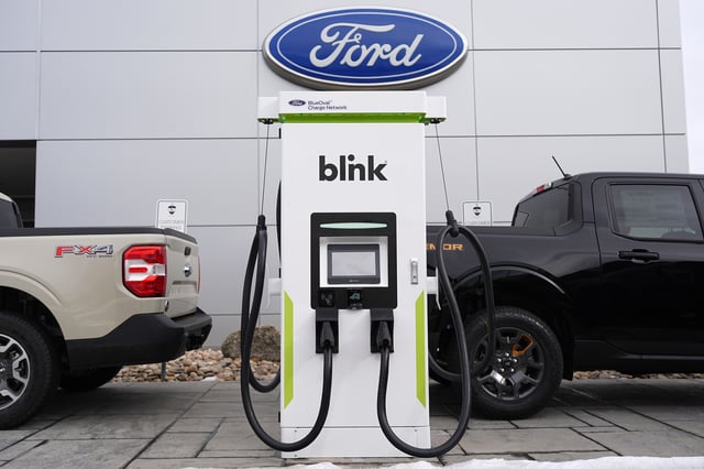 FILE - Electric vehicle chargers sit outside a Ford dealership, Jan. 21, 2024, in Broomfield, Colo. (AP Photo/David Zalubowski, File)