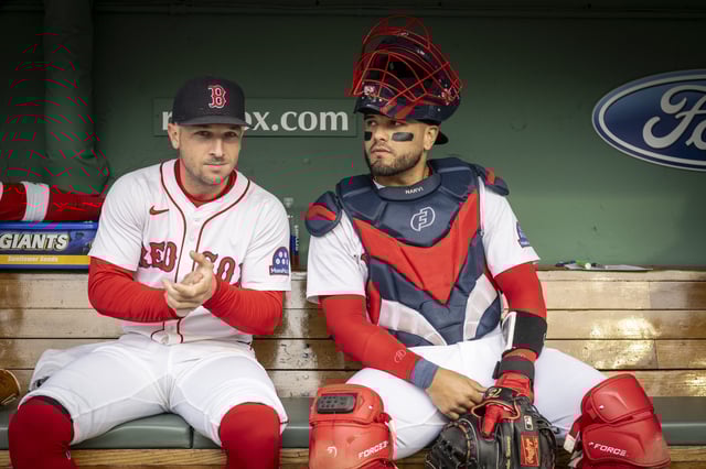 BOSTON, MASSACHUSETTS - MAY 23: Alex Bregman #2 of the Boston Red Sox and Carlos Narváez #75 of the Boston Red Sox look on in the dugout before game one of a doubleheader against the Baltimore Orioles at Fenway Park on May 23, 2025 in Boston, Massachusetts.