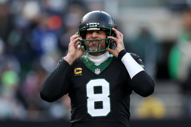 Aaron Rodgers #8 of the New York Jets puts on his helmet during the first quarter of a game against the Seattle Seahawks at MetLife Stadium on December 01, 2024 in East Rutherford, New Jersey.