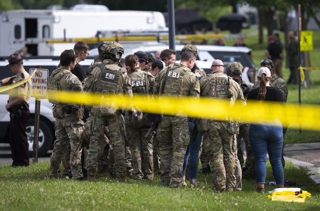 FBI agents stage in a neighborhood on June 15, 2025, in Green Isle, Minnesota. Law enforcement agencies were searching for Vance Boelter, a suspect in the killing of DFL State Rep. Melissa Hortman and her husband, Mark Hortman, who were shot at their home. (Photo by Stephen Maturen/Getty Images)