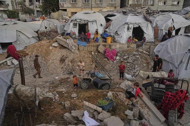 Displaced Palestinians live in a tent camp in Gaza City, Monday, June 23, 2025. (AP Photo/Jehad Alshrafi)