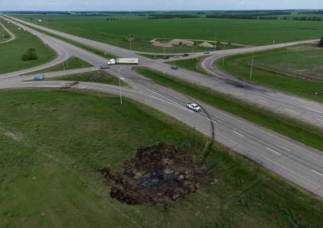 A scorched patch of ground where a bus carrying seniors ended up after colliding with a transport truck and is seen on the edge of the Trans-Canada Highway where it intersects with Hwy 5, near Carberry, Man., Friday, June 16, 2023. The crash killed 17 people. THE CANADIAN PRESS/Darryl Dyck