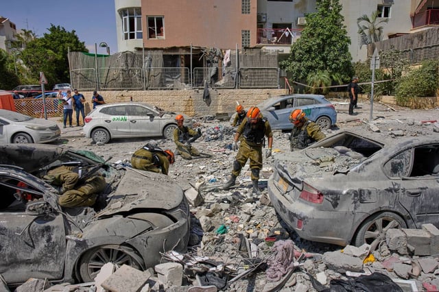 Israeli soldiers work amid the rubble of residential buildings destroyed by an Iranian missile strike that killed several people, in Beersheba, Israel, on Tuesday, June 24, 2025. (AP Photo/Bernat Armangue)
