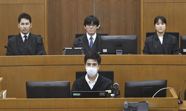 Judicial members, including Judge Kazuhiko Obata, center back, for the sexual assault case of U.S. Marine Lance Cpl. Jamel Clayton, at the Naha District Court in Okinawa.