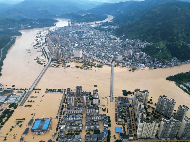 A drone view shows buildings and roads are half submerged in floodwaters after heavy rainfalls, in Rongjiang county, Guizhou province, China June 24, 2025. China Daily via REUTERS