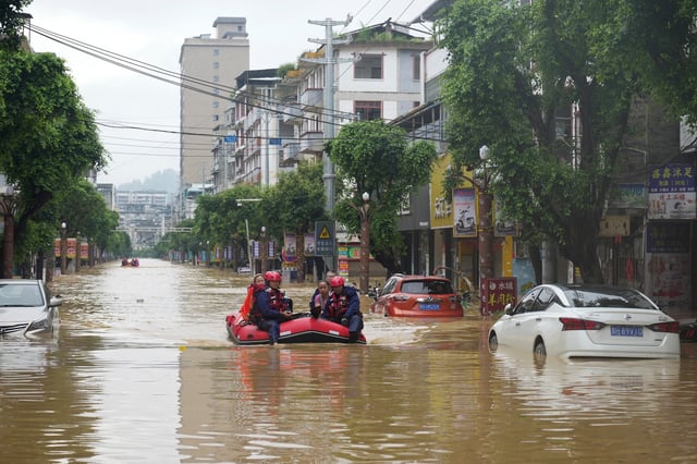 Rescue workers evacuate flood-affected residents with a boat in Rongjiang county, Guizhou province, China June 24, 2025. China Daily via REUTERS ATTENTION EDITORS - THIS IMAGE WAS PROVIDED BY A THIRD PARTY. CHINA OUT. NO COMMERCIAL OR EDITORIAL SALES IN CHINA.