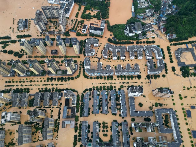 A drone view shows buildings and roads are half submerged in floodwaters after heavy rainfalls, in Rongjiang county, Guizhou province, China June 24, 2025. China Daily via REUTERS
