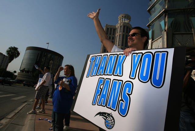 2008: Magic COO Alex Martins waves as the Orlando Magic have a thank you rally for their fans in front of the Orlando City Hall on May 16, 2008. They gave out milk, juice, water and doughnuts to commuters. (Ricardo Ramirez Buxeda/Orlando Sentinel)