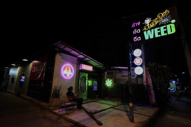 FILE--A customer sits outside a cannabis shop in Kanchanaburi province, west of Bangkok, Thailand, July 16, 2024. (AP Photo/Sakchai Lalit, File)