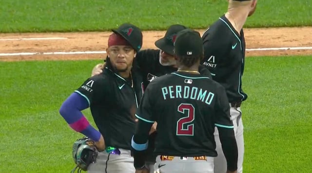 Manager Torey Lovullo consoles Arizona Diamondbacks' Ketel Marte after a fan heckled him.