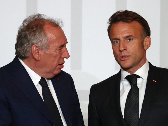 France's President Emmanuel Macron (R) speaks with France's Prime Minister Francois Bayrou during a ceremony to award craftspeople and officials who contributed to the restoration of Notre-Dame Cathedral at the Elysee Palace in Paris, on April 15, 2025. (Photo by Sarah Meyssonnier / POOL / AFP) (Photo by SARAH MEYSSONNIER/POOL/AFP via Getty Images)