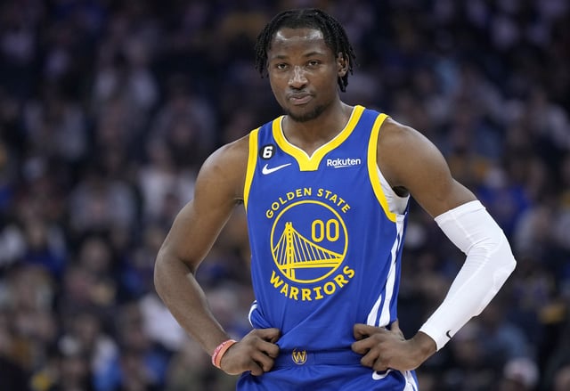 Jonathan Kuminga #00 of the Golden State Warriors looks on against the Portland Trail Blazers during the first quarter of an NBA basketball game at Chase Center on December 30, 2022 in San Francisco, California.
