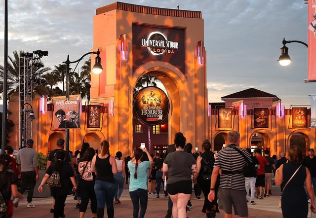 Guests walk toward the entrance to Halloween Horror Nights at Universal Studios Orlando on Thursday evening, October 21, 2021. Halloween Horror Nights is in its 30th year. (Stephen M. Dowell/Orlando Sentinel)