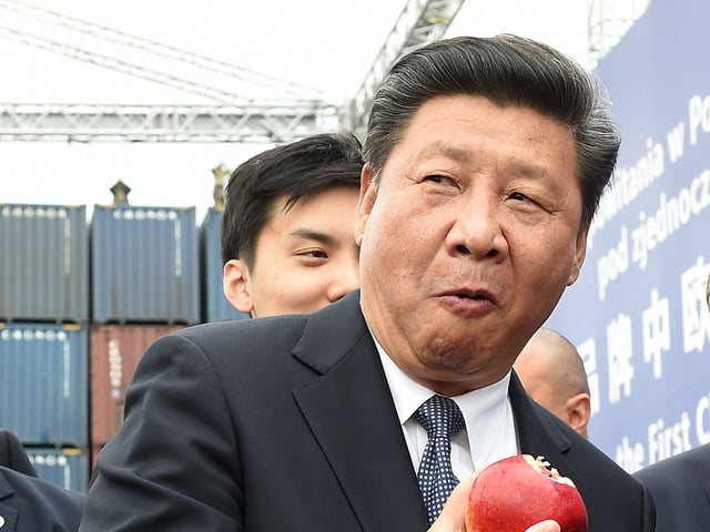 Chinese President Xi Jinping (L) and Polish President Andrzej Duda (R) eat Polish apples as they greet the arrival of the first China Railway Express train that rolled into the Polish capital from China ending a 13-day trip from Chengdu, capital of the central Sichuan province on June 20, 2016 in Warsaw. Chinese President Xi Jinping was in Warsaw to boost China's trade and investment with Poland, the European Union's largest eastern economy. / AFP / JANEK SKARZYNSKI (Photo credit should read JANEK SKARZYNSKI/AFP via Getty Images)