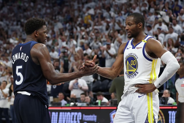 Anthony Edwards of the Minnesota Timberwolves shakes hands with Jonathan Kuminga of the Golden State Warriors after the Timberwolves won Game 5 of the Western Conference semifinals at Target Center in Minneapolis on May 14, 2025. 
