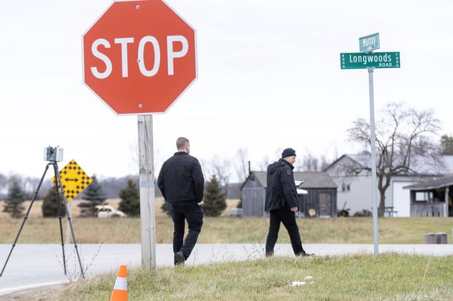 London police investigators survey the intersection of Longwoods and Murray roads in southwest London on Thursday, Dec. 19, 2024, as they investigated a crash that caused fatal injuries to Dante Caranci after he exited a school bus. (Derek Ruttan/The London Free Press)