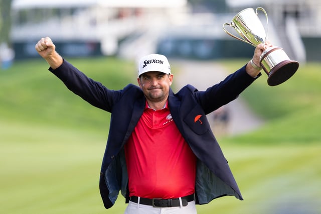 Jun 22, 2025; Cromwell, Connecticut, USA; Keegan Bradley raises the Travelers Championship trophy after winning the Travelers Championship golf tournament. Mandatory Credit: Bill Streicher-Imagn Images/File Photo