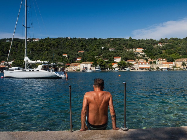 DUBROVNIK, CROATIA - JULY17: A tanned man is seen getting into the water on ipan island, the largest of the three inhabited Elaphiti Islands near Dubrovnik, Croatia on July 17, 2024. Called the "pearl of the Adriatic," the Old Town of Dubrovnik is listed as a UNESCO World Heritage Site, with its well-preserved medieval architecture and fortifications. (Photo by Jay L Clendenin/Getty Images)