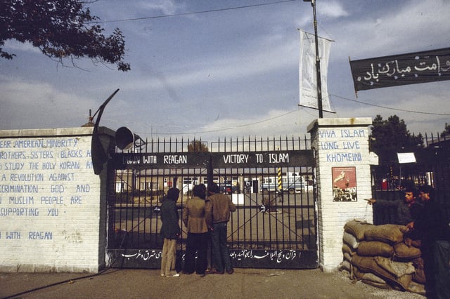 FILE - The entrance to the U.S. Embassy in Tehran, Iran, where 63 people are being held hostage, seen in 1980. Graffiti on the wall at left reads: "Dear American minority, brothers and sisters (Blacks and Indians) study the holy Koran and start a revolution against U.S. discrimination. God and Iranian Muslim people are supporting you. Down with Reagan." (AP Photo, File)
