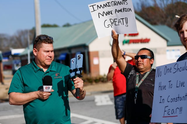 Mario Guevara covers a protest against immigration enforcement on Buford Highway, Ga., on Feb. 1, 2025.