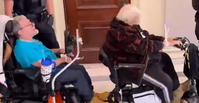 disabled protesters with zip ties around wrists