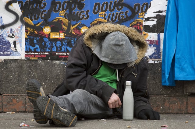A man sits on a sidewalk on East Hastings Street in Vancouver's Downtown Eastside on Feb 7, 2019. More people fatally overdosed in British Columbia last year compared with 2017 despite efforts to combat the province's public health emergency, the coroner says.THE CANADIAN PRESS/Jonathan Hayward