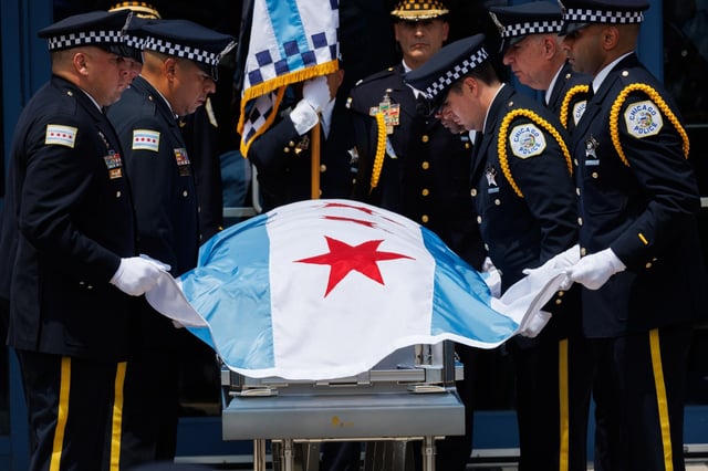 Officers prepare to remove a Chicago flag from the casket of slain Chicago police Officer Krystal Rivera during her funeral at Living World Christian Center on June 25, 2025, in Forest Park. Rivera was unintentionally shot and killed by a fellow officer on June 5 after a confrontation with an armed suspect. (Armando L. Sanchez/Chicago Tribune)