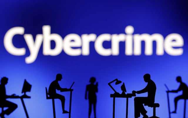 Figurines with computers and smartphones are seen in front the word "Cybercrime" in this illustration taken, February 19, 2024. REUTERS/Dado Ruvic/Illustration