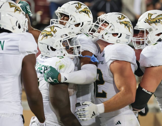 Sacramento State running back Marcus Fulcher (9) is congratulated by teammates after scoring a touchdown during the fourth quarter against Stanford at Stanford Stadium on Sept. 16, 2023.