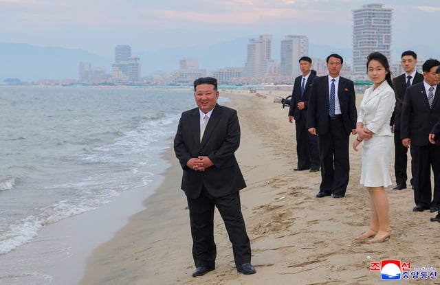 North Korean leader Kim Jong Un and his daughter Kim Ju Ae stand on the beach during a ceremony to celebrate the completion of the Wonsan Kalma Coastal Tourist Zone, in Wonsan, North Korea, June 24, 2025.  KCNA via REUTERS