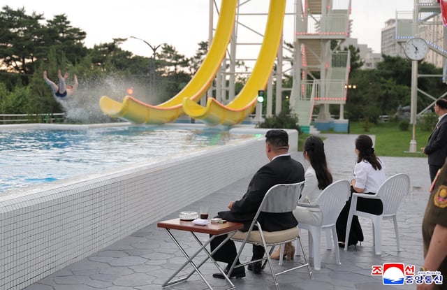 North Korean leader Kim Jong Un and his daughter Kim Ju Ae watch a person sliding down a slide during a ceremony to celebrate the completion of the Wonsan Kalma Coastal Tourist Zone, in Wonsan, North Korea, June 24, 2025.  KCNA via REUTERS