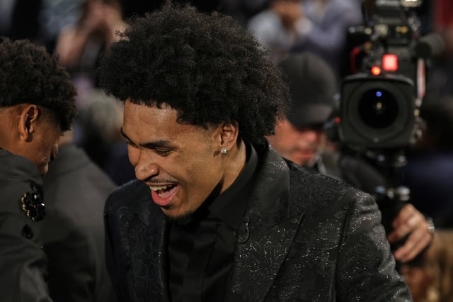 Dylan Harper reacts after being selected second by the San Antonio Spurs In the first round of the NBA basketball draft, Wednesday, June 25, 2025, in New York. (AP Photo/Adam Hunger)