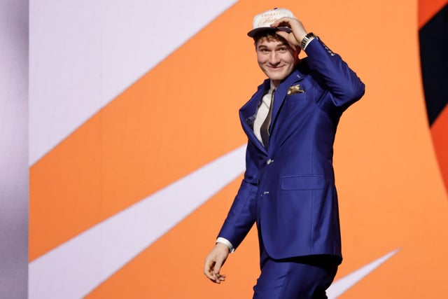 Liam McNeeley reacts after being selected 29th by the Phoenix Suns in the first round of the NBA basketball draft, Wednesday, June 25, 2025, in New York. (AP Photo/Adam Hunger)