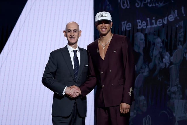Carter Bryant shakes hands with NBA commissioner Adam Silver after being drafted fourteenth overall by the San Antonio Spurs during the first round of the 2025 NBA Draft at Barclays Center on June 25, 2025 in the Brooklyn borough of New York City.