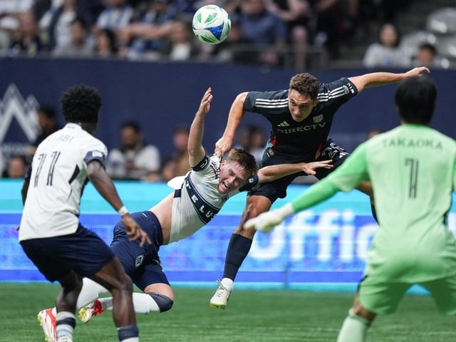  San Diego FC’s Ian Pilcher, back right, pulls down Vancouver Whitecaps’ Tate Johnson, back left, as they vie for the ball during the first half of an MLS soccer match, in Vancouver, on Wednesday, June 25, 2025.