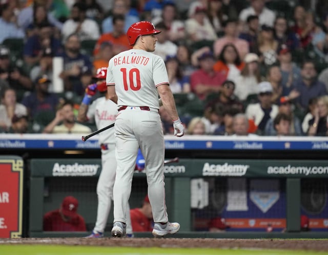 Philadelphia Phillies&#39; J.T. Realmuto (10) reacts after striking out against Houston Astros relief pitcher Josh Hader during the ninth inning of a baseball game, Wednesday, June 25, 2025, in Houston. (AP Photo/Karen Warren)