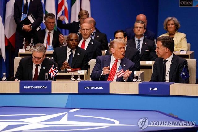 This AFP photo shows U.S. President Donald Trump (2nd from R) talking with Mark Rutte, secretary-general of the North Atlantic Treaty Organization (NATO), at the NATO summit held in The Hague on June 25, 2025. (Yonhap)