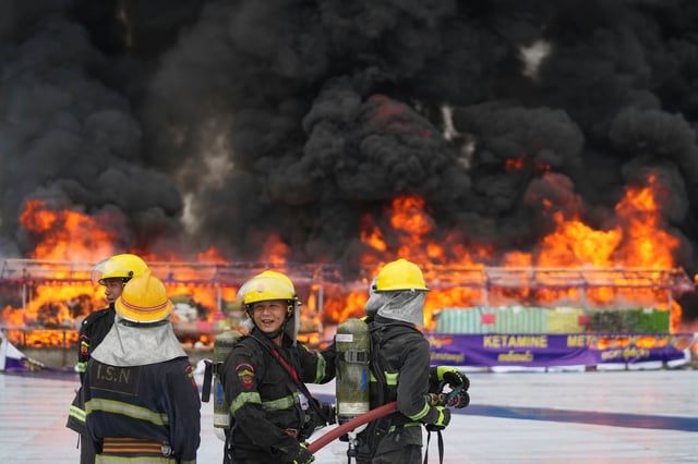 Firefighters stand by near burning illegal narcotics during a destruction ceremony to mark International Day against Drug Abuse and Illicit Trafficking, on the outskirts of Yangon, Myanmar, Thursday, June 26, 2025. (AP Photo/Thein Zaw)